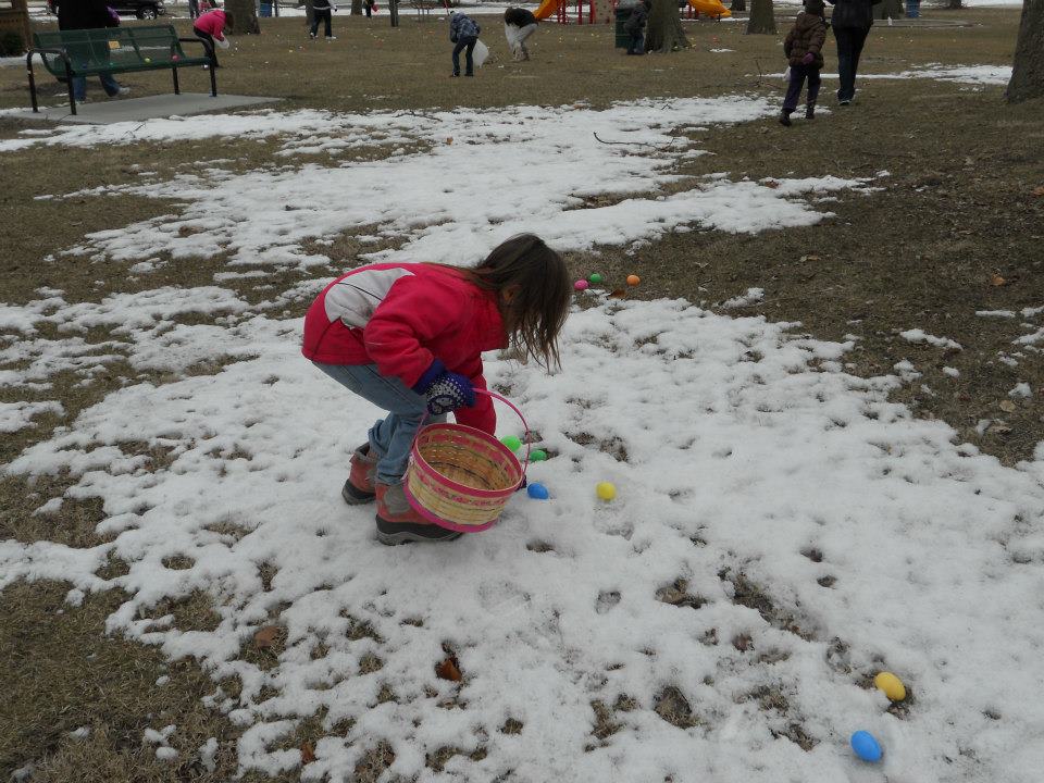 girl hunting eggs in snow
